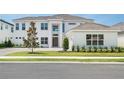 Beautiful two-story home with a brick driveway, well-maintained lawn, and a modern front door at 6125 Village Edge Pl, Sanford, FL 32771