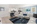 Modern open-concept living room flowing into the kitchen and dining area at 7041 Oakwood St, Davenport, FL 33837