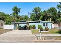 Charming single-story home with a covered outdoor seating area and well-maintained landscaping at 793 Greenway Pl, Daytona Beach, FL 32114