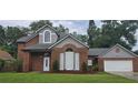 Charming two-story brick home with landscaped yard, mature trees and a two car garage at 8612 Valley Ridge Ct, Orlando, FL 32818