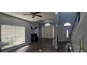 Open living room featuring wood floors, ceiling fan, neutral walls, and large window with a lot of natural light at 8612 Valley Ridge Ct, Orlando, FL 32818