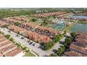 Gorgeous aerial view of a residential community with lush landscaping, a resort-style pool, and scenic lakes at 8919 Bismarck Palm Rd, Kissimmee, FL 34747