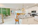 Open concept kitchen with granite countertops, stainless steel appliances and a large island with barstool seating at 8940 Coconut Breeze Dr, Kissimmee, FL 34747