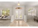 Elegant foyer featuring tile flooring, decorative glass double doors, and arched windows at 926 Ridgeland Ct, Apopka, FL 32712