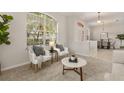Bright living room showcasing a sitting area with plush chairs and natural light at 926 Ridgeland Ct, Apopka, FL 32712