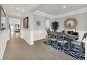 Dining room featuring wood floors, decorative mirror, and elegant wainscoting throughout at 11057 Hollow Bay Dr, Winter Garden, FL 34787