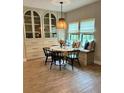 Bright dining area featuring a built-in banquette, modern table, and elegant decor at 1266 Spotted Sandpiper Loop, Winter Springs, FL 32708