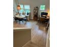 Open-concept living space with dining area, built-in bench and a convenient home office setup at 1266 Spotted Sandpiper Loop, Winter Springs, FL 32708