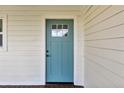 Close up of a traditional front door in a blue color, complemented by white trim and horizontal siding at 1341 W Belmar St, Lakeland, FL 33815