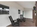 Relaxing front porch featuring rocking chairs and a small table, ideal for enjoying the outdoors at 1341 W Belmar St, Lakeland, FL 33815