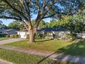 Well-maintained home with a green lawn and a large tree providing shade and curb appeal at 146 Tollgate Trl, Longwood, FL 32750