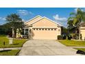 Inviting single-story home with a spacious driveway and a manicured lawn, offering curb appeal at 15637 Carina Dr, Orlando, FL 32828