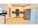 Modern kitchen with stainless steel appliances, tile backsplash, and a pantry, designed for convenience at 15637 Carina Dr, Orlando, FL 32828