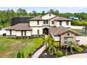 Beautiful two-story home featuring manicured landscaping, stone accents, and a screened-in pool at 2245 Bronco Dr., St Cloud, FL 34771