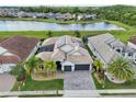 Stunning aerial view of a home, highlighting its prime location with a picturesque lake and well-manicured surroundings at 2586 Lancaster Ridge, Davenport, FL 33837