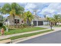 Beautiful single-Gathering home with a three-car garage, lush landscaping, and well-maintained lawn at 2586 Lancaster Ridge, Davenport, FL 33837