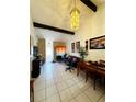 Inviting living area featuring vaulted ceilings, tiled floors, and abundant natural light from a large window at 2716 Upsandown St, Orlando, FL 32837