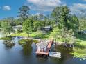 Aerial view of the property featuring a lake, dock, gazebo, and lush green lawns at 277 Sunrise Pt, Lake Mary, FL 32746