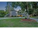 Charming two-story home featuring a stone facade, mature trees and a circular driveway at 277 Sunrise Pt, Lake Mary, FL 32746