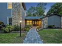 Inviting front entrance with a paved walkway, manicured garden beds and stone accents at 277 Sunrise Pt, Lake Mary, FL 32746