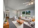 Bright living room with neutral walls, large windows, comfortable seating, and stylish decor at 3090 Yorkshire Dr, Deltona, FL 32738