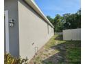 Exterior view of the side of the house showing a walkway and a fence at 3265 Stratton Cir, Kissimmee, FL 34744