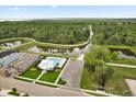 An aerial view of a community pool near a walking trail and lakes surrounded by a lush Florida landscape at 3635 Arbordale Loop, Sanford, FL 32771