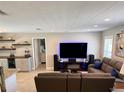 Comfortable living room with entertainment center, leather seating and views into the kitchen and secondary rooms at 415 Seville Ave, Altamonte Springs, FL 32714