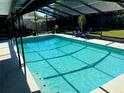 Relaxing screened-in pool area featuring clear blue water and comfortable seating for outdoor enjoyment at 415 Seville Ave, Altamonte Springs, FL 32714
