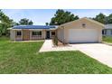 Charming single-story home with a well-maintained lawn and solar panels on the roof at 525 Southport Dr, Longwood, FL 32750