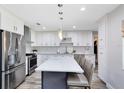 Modern kitchen with stainless steel appliances, quartz countertops, a center island, and ample cabinet space at 525 Southport Dr, Longwood, FL 32750