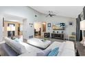 Bright living room with vaulted ceilings, ceiling fan, luxury vinyl flooring, and a modern aesthetic at 525 Southport Dr, Longwood, FL 32750