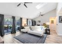 Bright living room with high ceilings, modern furnishings, and sliding glass doors to the patio at 525 Southport Dr, Longwood, FL 32750
