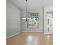 Bright living room featuring tile floors, high ceilings, a chandelier and a large window offering exterior views at 548 Casterton Cir, Davenport, FL 33897