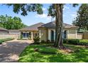 Inviting single-story home featuring mature landscaping and a private driveway leading to the entrance at 5973 Chesapeake Park # 58, Orlando, FL 32819