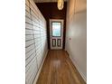 Inviting entryway featuring hardwood floors and decorative glass front door at 6615 Beamer Way, Orlando, FL 32807
