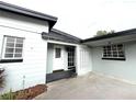 Home exterior showcases a concrete driveway and walkways leading to a welcoming front entrance with detailed features at 6615 Beamer Way, Orlando, FL 32807