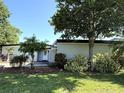 Inviting single-story home with a well-kept lawn, landscaping, and a spacious driveway leading to the entrance at 6615 Beamer Way, Orlando, FL 32807