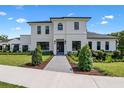 Beautiful two-story home featuring modern design, a well-manicured lawn, and a paved walkway leading to the entrance at 734 Terra Pl, Maitland, FL 32751