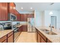 Modern kitchen featuring granite countertops, stainless steel appliances, and ample cabinet space at 87 Delacorte Way, Oviedo, FL 32765