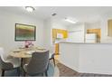 Dining area with seating for four and a view into the kitchen at 8824 Villa View Cir # 204, Orlando, FL 32821