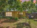 This backyard offers a serene, partially shaded space with trees, a small patio, and a well-maintained grassy area at 920 Gloriosa Ave, Winter Park, FL 32789