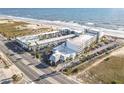 Aerial view of Ocean Jewels Club resort with lush palm trees, parking, and the beach in Daytona Beach Shores, FL at 935 S Atlantic Ave # 355, Daytona Beach, FL 32118
