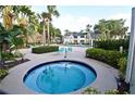 Community hot tub and seating area surrounded by lush, tropical landscaping at 1051 S Hiawassee Rd # 2136, Orlando, FL 32835