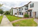 Well-maintained townhouses with gated entrances, lush landscaping, and tidy sidewalks create curb appeal at 109 Kenny Blvd, Haines City, FL 33844