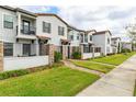 Charming townhouses showcase gated entrances, well-kept lawns, and brick pathways in a row at 109 Kenny Blvd, Haines City, FL 33844