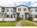 Attractive townhouse boasts gated entry, lush landscaping, private balconies, and a welcoming facade at 109 Kenny Blvd, Haines City, FL 33844