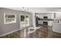 Bright kitchen with stainless steel appliances, white cabinetry, and sliding doors to the backyard at 11572 Se 60Th Ave, Belleview, FL 34420