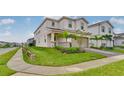 Landscaped home featuring a well-manicured lawn and inviting curb appeal in a sidewalk community at 1221 Aloha Blvd, Davenport, FL 33897