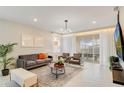 Bright living room with modern furnishings, a large sliding glass door, and stylish decor at 1221 Aloha Blvd, Davenport, FL 33897